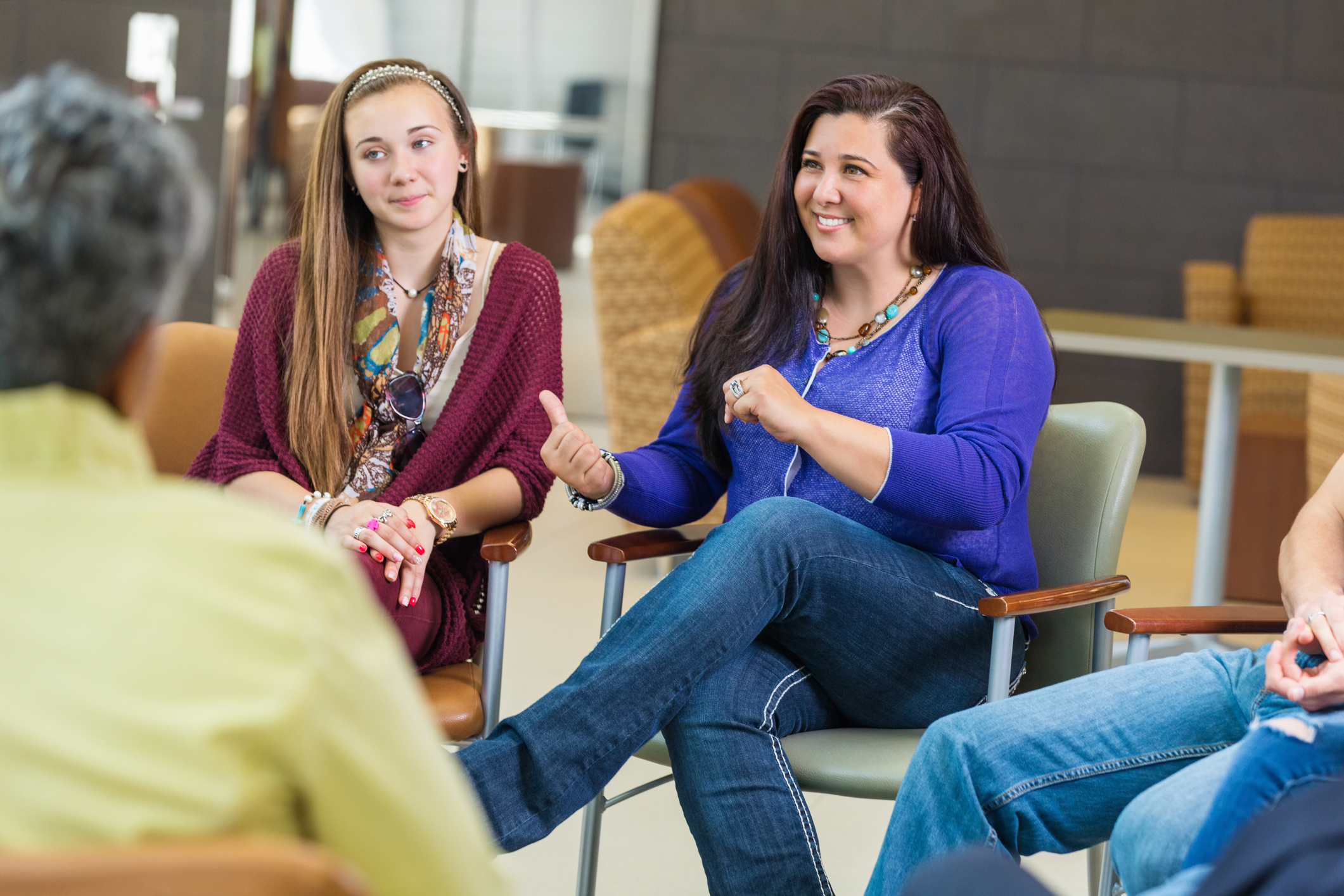 Woman discussing something with diverse group of people